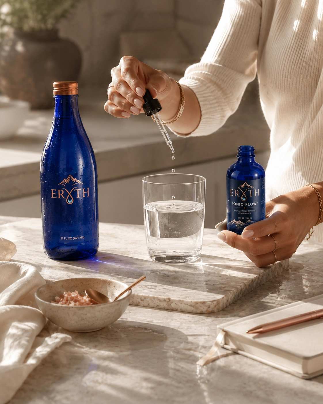 ERYTH Ionic Flow daily ritual — trace mineral drops in water Adding ERYTH Ionic Flow trace mineral drops to a glass of water